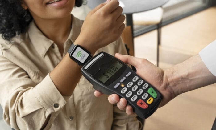 person-paying-using-nfc-technology-746x450